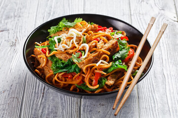 grilled soy meat strips with egg noodle in a bowl