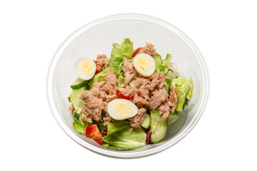Fresh tuna salad with lettuce, cucombers, cherries and eggs in plastic container.