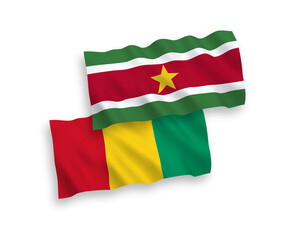 Fototapeta premium National vector fabric wave flags of Republic of Suriname and Guinea isolated on white background. 1 to 2 proportion.