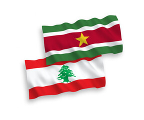 National vector fabric wave flags of Republic of Suriname and Lebanon isolated on white background. 1 to 2 proportion.