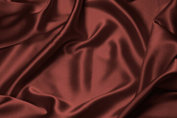 Rich and luxury red silk fabric texture background.