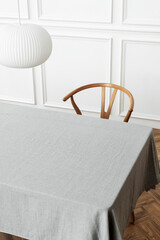 Fototapeta na wymiar Minimal tablecloth on a table in a dining room
