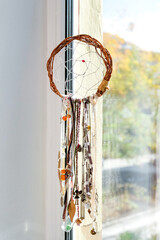 Homemade dream catcher hanging by the window