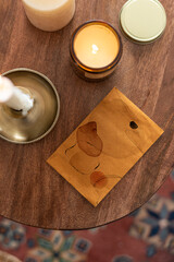 Flay lay envelope with candles on wooden table