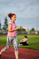 Woman running on track