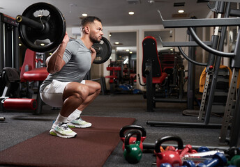 Fitness man doing barbell squats