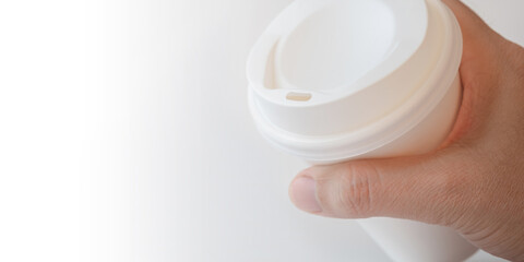 Close up of Man Hand Holding a Paper Coffee Cup on White Background, Copy Space for Text.