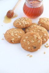 stack of whole meal cookies and honey on wooden background