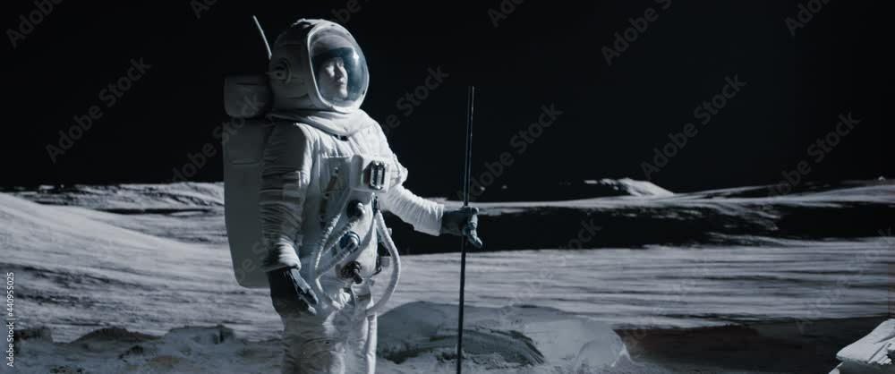 Wall mural portrait of asian lunar astronaut standing with a flag pole on the moon surface. easy to track and a
