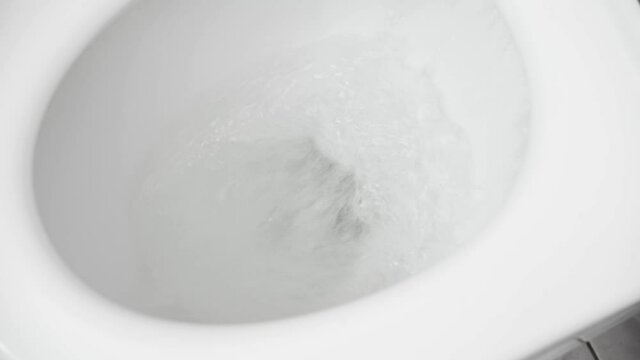 the water is flushed into the white toilet