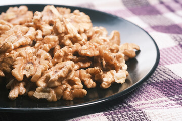 walnut on a plate on table , close up.