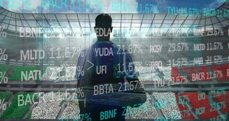 Stock market data processing over rear view of male rugby player against sports stadium - Powered by Adobe