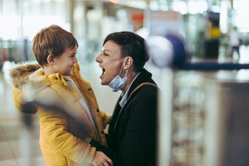 Woman excited to meet her son at airport