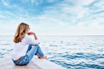Fototapeta na wymiar Full length shot of a woman relaxing by the sea
