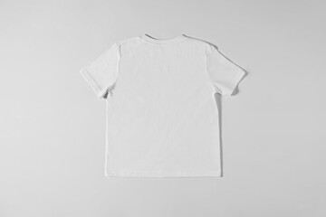 White T-shirt lying on a light background