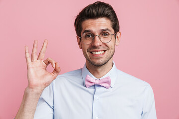 Portrait of a smiling young brunette nerd man