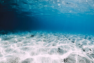 Transparent blue ocean with white sand underwater in Hawaii