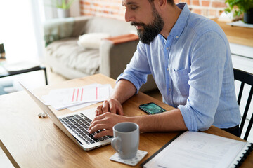 Man working using a laptop while home office