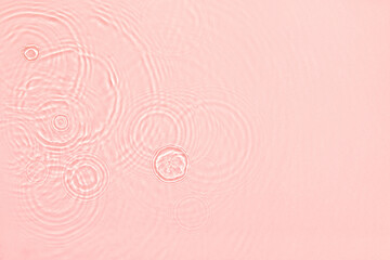 Pink transparent clear calm water surface texture with ripples, splashes and bubbles Abstract...