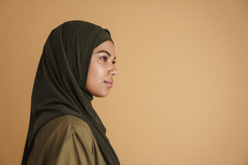 Black muslim woman in hijab posing and looking aside