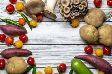 Various kinds of vegetables on the white wood-textured background.