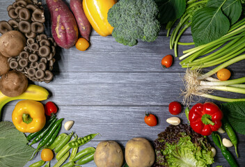 Various vegetables and fruits on the wood pattern background.