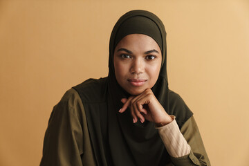 Black muslim woman in hijab posing and looking at camera