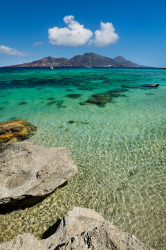 View of the southern coast of the Greek islet of Gyali and the island of Nyssiros, part of the Dodecanese archipelago