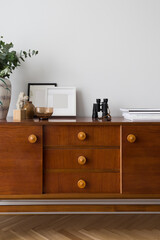 Many stylish decorations on retro style sideboard