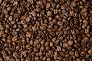 Light roasted coffee beans Poured from the hands and from the glass Taken on a black background