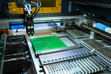 Machine applies transistor lines to microboard. Manufacturing process of computer boards. Automatic soldering on digital boards. Computer industry. Automatic micro board soldering machine.