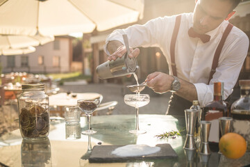 Barman is making a cocktail outdoor