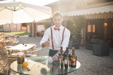 Barman is making a cocktail outdoor