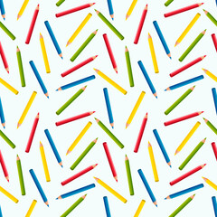 Seamless pattern of colored pencils on a white background.