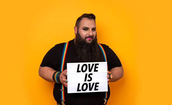 Big bearded gay man with a love is love message