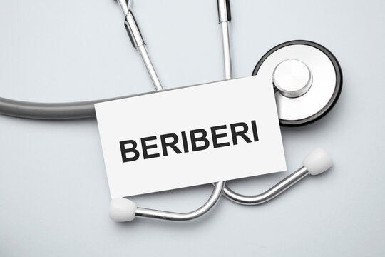 Paper with beriberi on a table and grey stethoscope