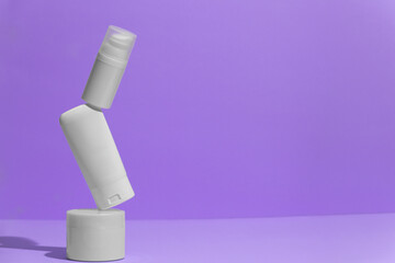 Set of blank white skincare cosmetic products on background with free space for advertising text. Floating empty moisturizer and hygiene bottle.