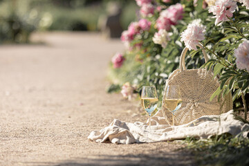 Romantic picnic on the lawn with peonies. © Kotkoa