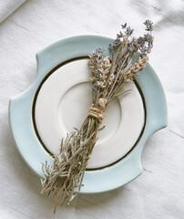 A bunch of dry lavender on a beautiful saucer. Lavender aromatherapy                 