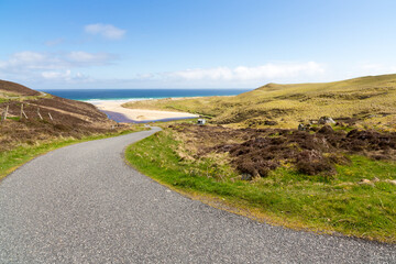 Single track road leading down to the beach at North Tolsta Isle of Lewis Outer Hebrides Scotland UK