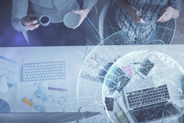 Double exposure of man and woman working together and social network theme hologram drawing. Computer background. connecting concept. Top View.