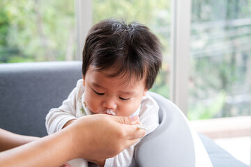 Mother feeding food for his children.The child eats with pleasure. Hungry crying infant.  Baby healthcare and family activity concept.