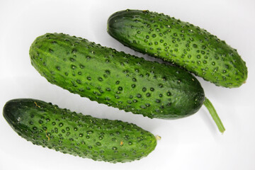 Green cucumbers on a white background. Healthy eating.