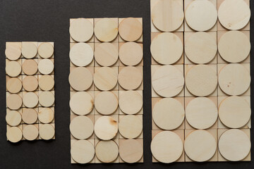 background composed of thin, untreated or natural round and square wooden shapes - loosely arranged...