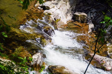 rough water in the mountains, water flows over the rocks, forest, nature, mountains, waterfall, background