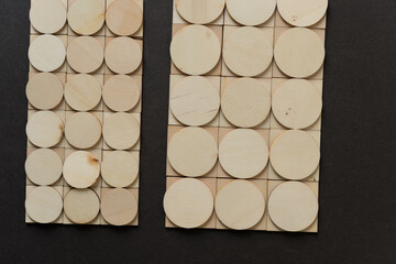 background composed of thin, untreated or natural round and square wooden shapes - loosely arranged...