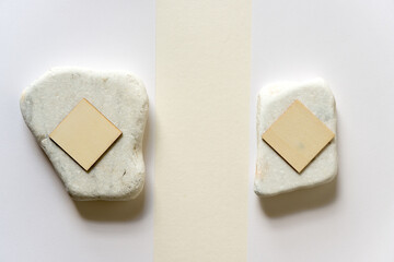 square wooden shapes, stone, and paper background