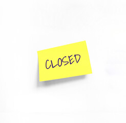 Isolated Yellow sticker with Closed Handwriting text on white Whatman paper. Concept programming, testing, business. Handwriting text, copy space