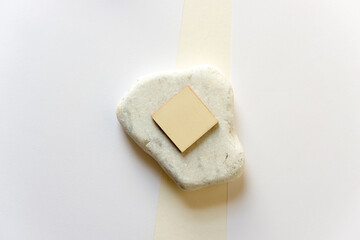 square wooden shapes, stone, and paper background