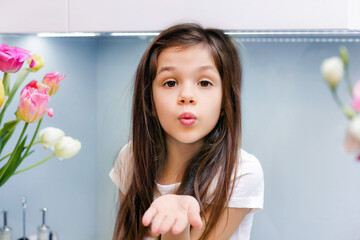Cute little girl blowing kisses away